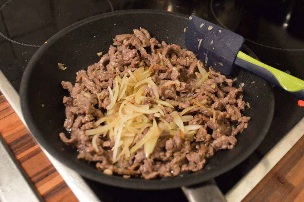 Beef and onions cooking for bún bò Köln