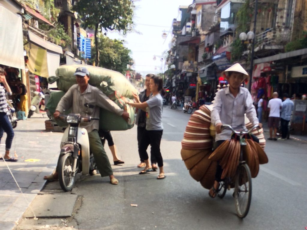 Motorbike with large sacks and bike with baskets, Hanoi, Vietnam