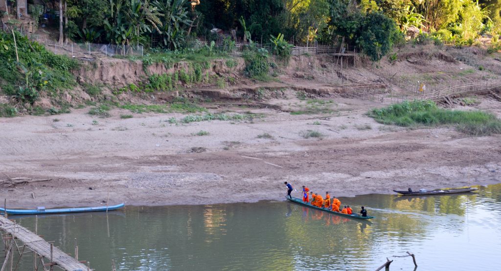 Monks crossing the Nam Khan River in Luang Prabang, Laos