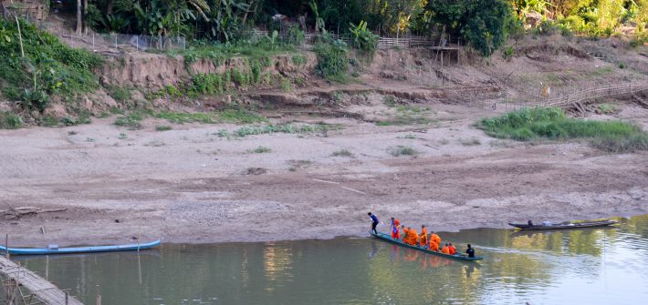 Monks crossing the Nam Khan River in Luang Prabang, Laos