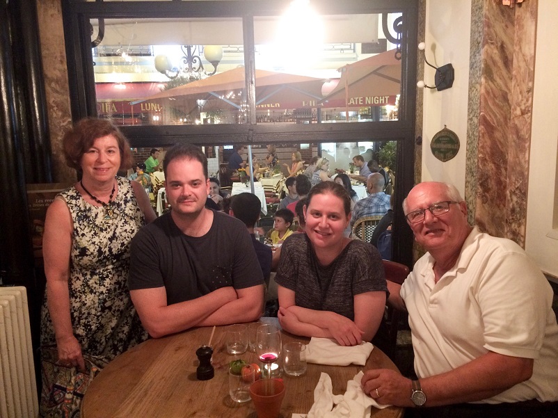 Four family members sitting at a table in Nice, France