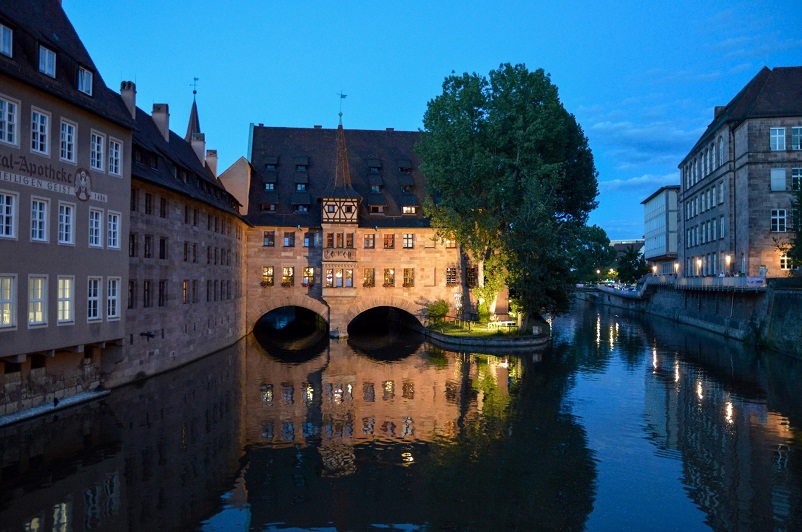A lovely building over a river at night in Nuremberg