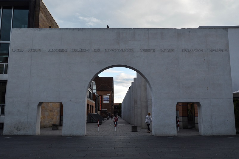 A white, arched entrance gate to the Way of Human Rights in Nuremberg, Germany