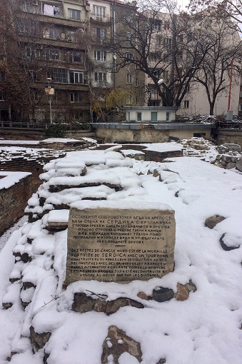 A stone block referencing the ruins of ancient Serdica in the snow in Sofia, Bulgaria
