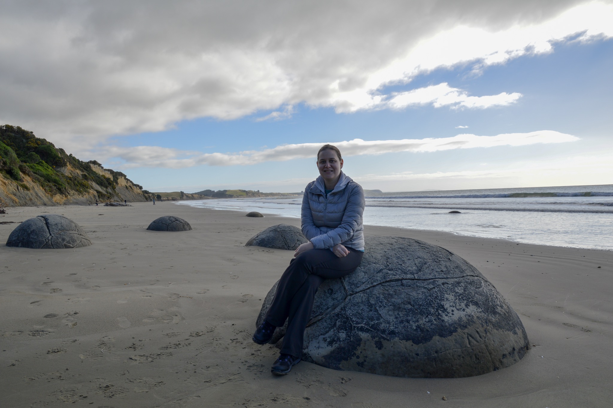 Sarah on a Moeraki Boulder in New Zealand