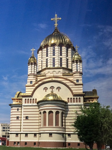 White Orthodox Cathedral with golden domes in Făgăraș, Romania