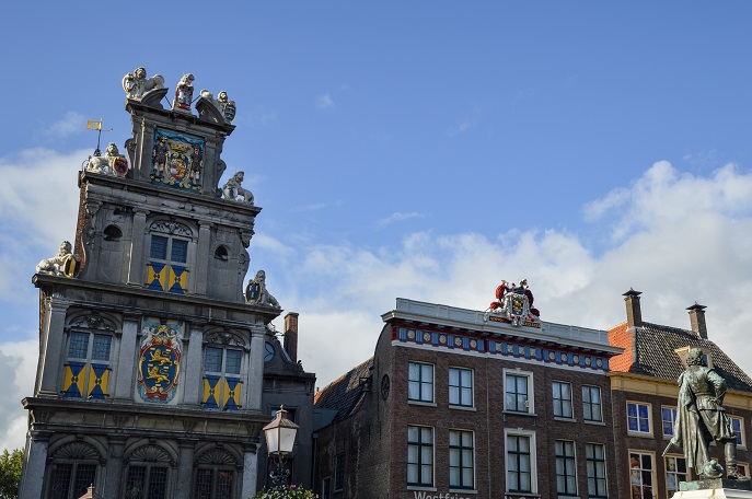 An extremely ornate building and a statue in Hoorn, the Netherlands
