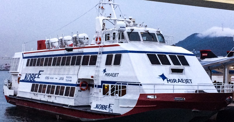 White, blue, and red ferry bot docked in Busan, South Korea after coming from Japan