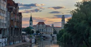 Sunset over a river in Oradea, one of our favorite places to visit in Romania