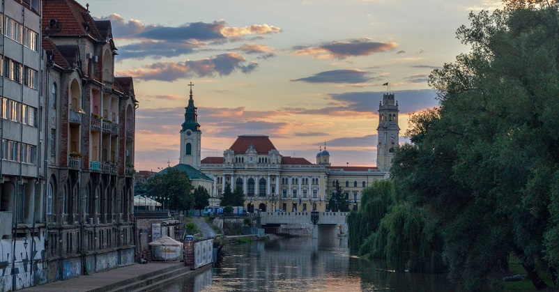 Sunset over a river in Oradea, one of our favorite places to visit in Romania