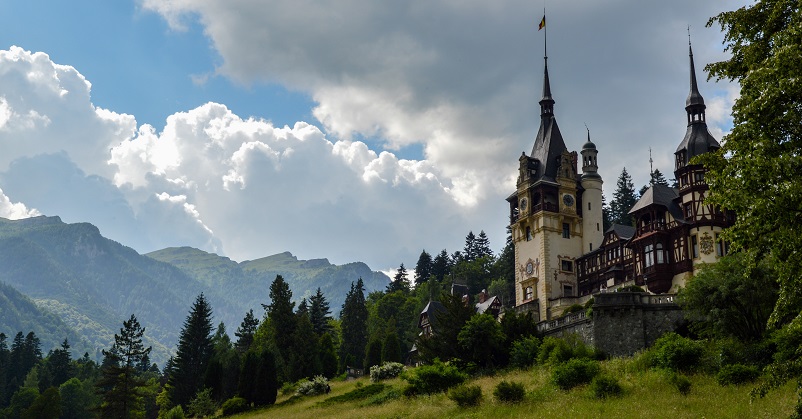 View of Peles Castle and Carpathian mountains in Sinaia, Romania