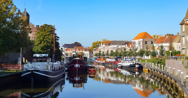 Boats in a small canal harbor in Zwolle, one of the best places to visit in the Netherlands