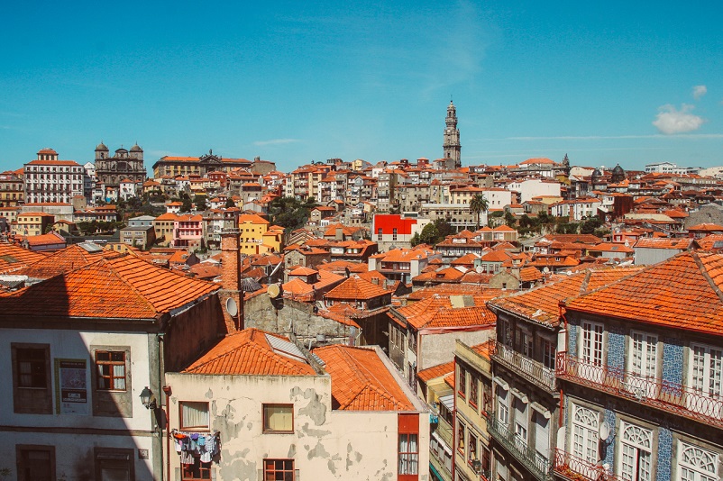 Red roofed buildings and a clock tower in the distance in Porto, Portugal