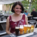 Female beer blogger sitting with a tasting plank