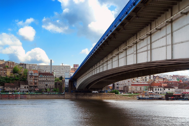 Close-up of under side of bridge leading to buildings on other side of river in Belgrade, Serbia