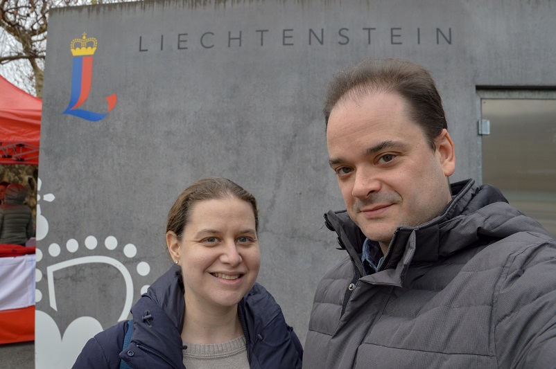 Sarah and Justin celebrating their Liechtenstein visit in front of the country's sign