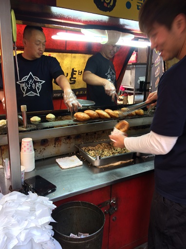 Three men making ssiat hotteok in Busan, South Korea