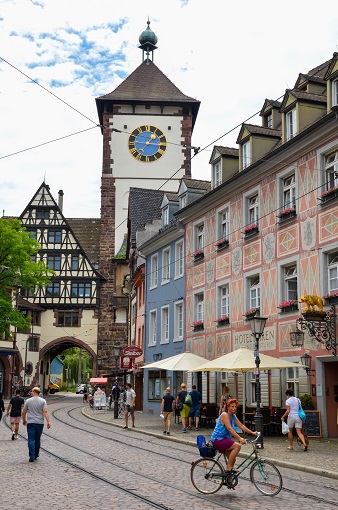 Street with half-timbered houses and a large tower - Schwabentor, Freiburg, Germany