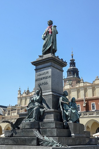 Statue of a man - Adam Mickiewicz - wearing a scarf in Main Market Square in Krakow