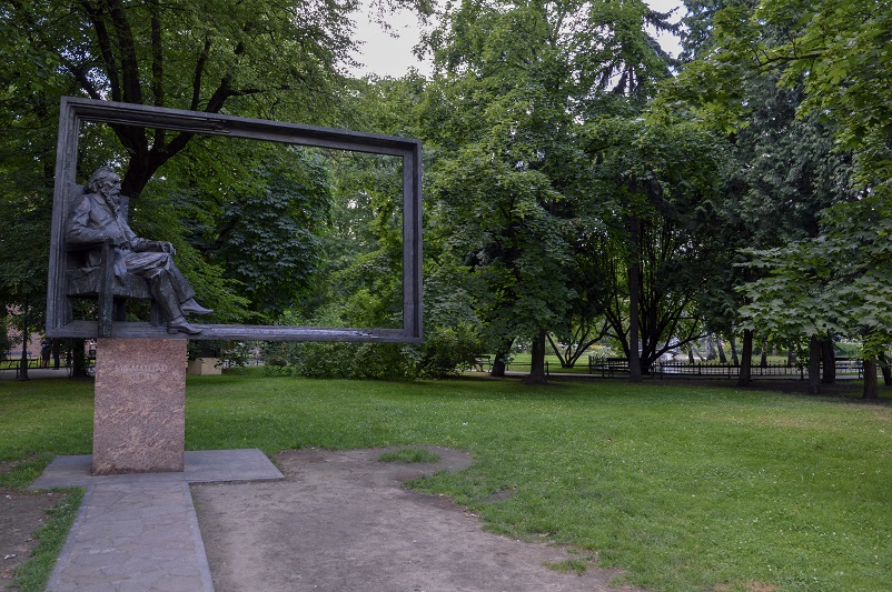 Sculpture of a man inside a frame in a park - Planty - in Krakow