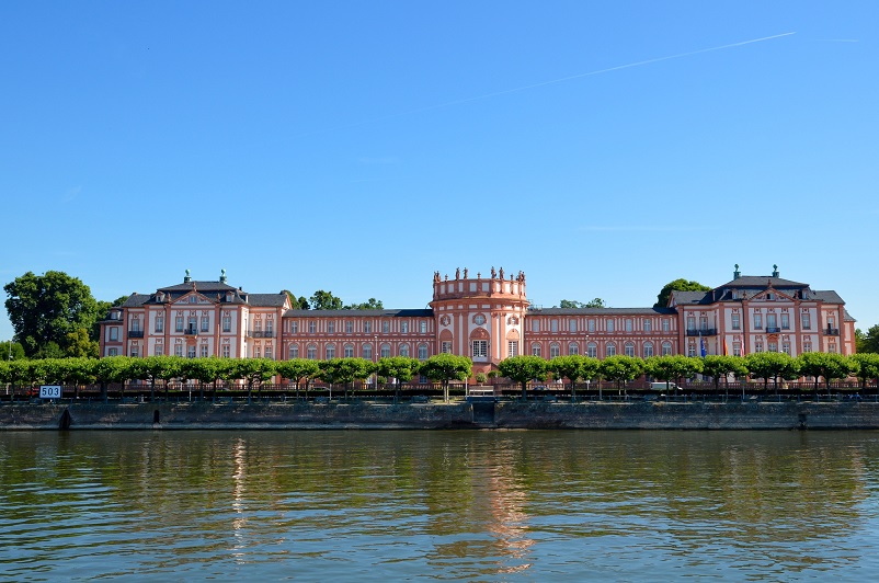 Massive pink building - the Electoral Palace - as seen across the Rhine River in Mainz, Germany