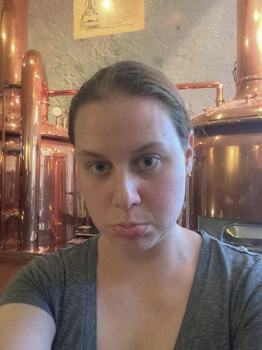 Frowning woman (Sarah) in front of beer kettles at Eisgrub in Mainz