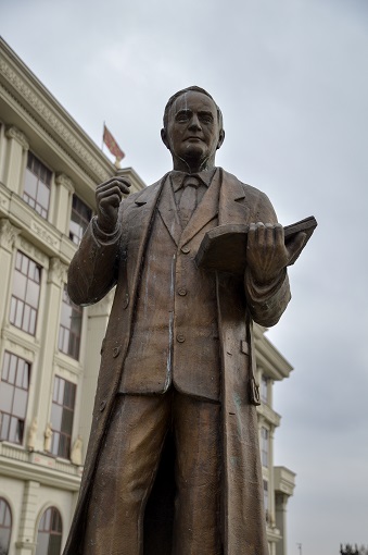 Statue of a man with a book in Skopje