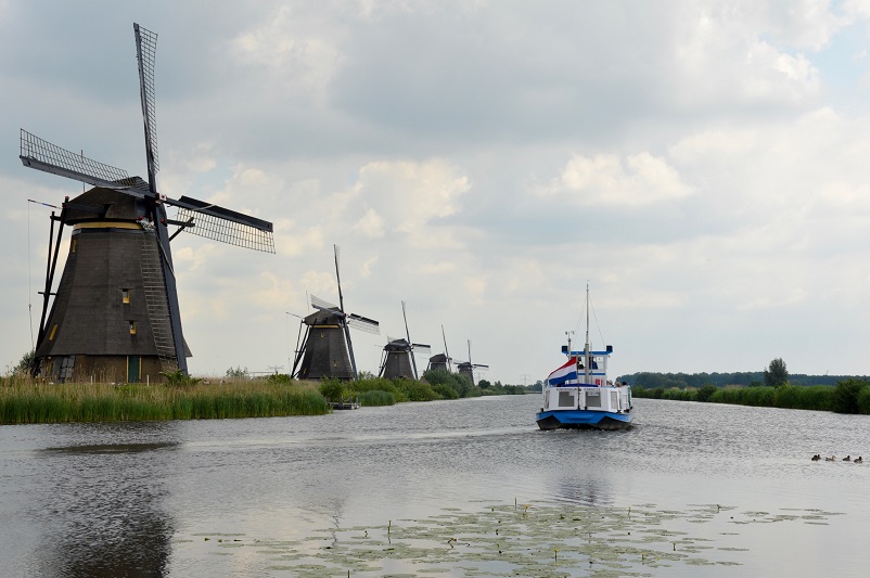 Windmills and a boat at Kinderdijk in the Netherlands