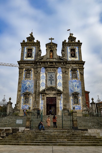 Close-up of the facade of Church of Saint Ildefonso covered in blue and white azulejo tiles in Porto