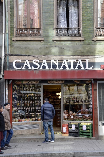 Justin in front of a storefront with the sign CASANATAL in Porto