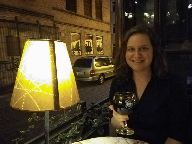 Sarah holding a Polish craft beer at Stacja Cafe in Poznan