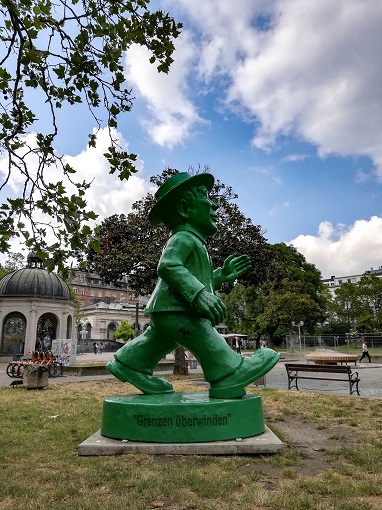Side view of sculpture of green Ampelmann in Wiesbaden