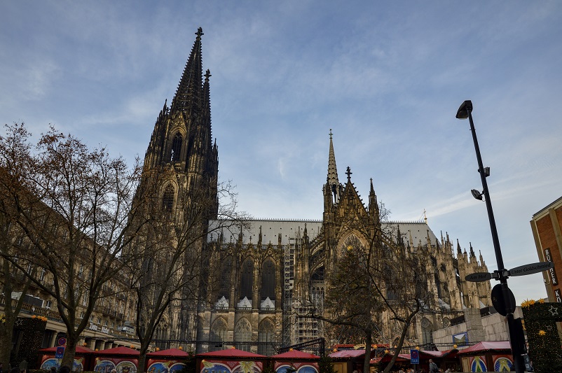 The massive cathedral towering above red tents of one of the Cologne Christmas Markets