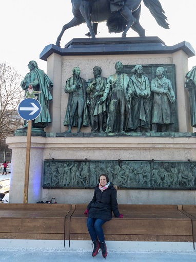 Sarah resting on a bench after ice skating at a Cologne Christmas Market