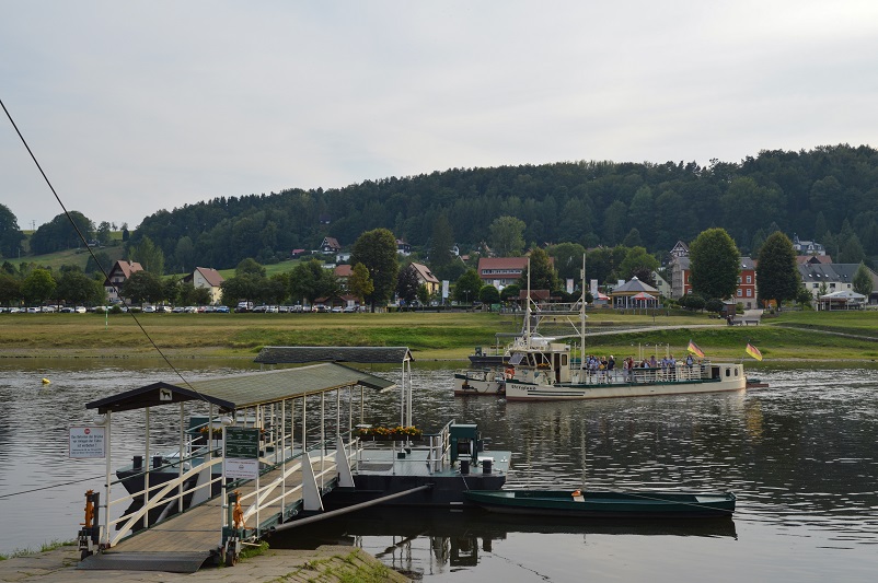 Dock and boat on Elbe River in Rathen, Germany