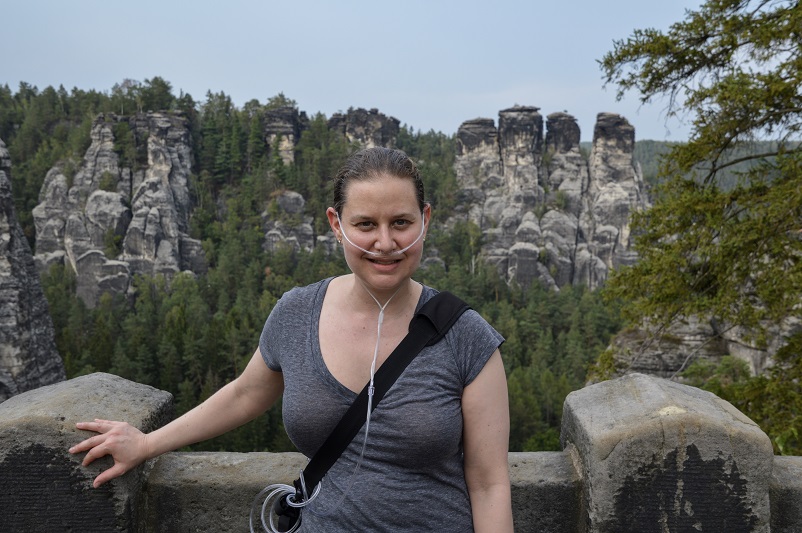 Sarah with her portable oxygen concentrator on Bastei Bridge