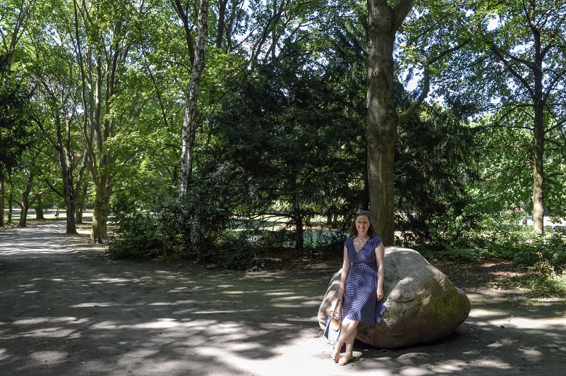 Sarah sitting on a rock in a park in Berlin