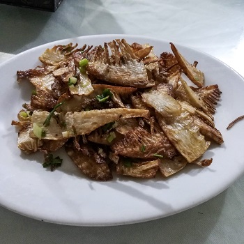 A plate of fried bamboo shoots, eaten on a Shanghai food tour
