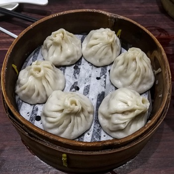 6 soup dumplings in a steamer on a Shanghai food tour
