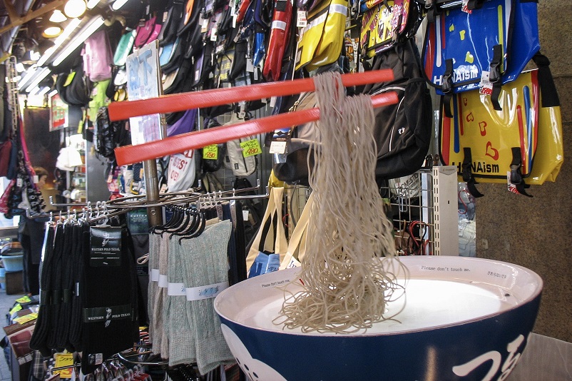 Enormous chopsticks holding noodles in Tokyo, Japan