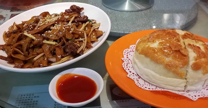 Noodles, hot sauce, and bread on a Shanghai Food Tour