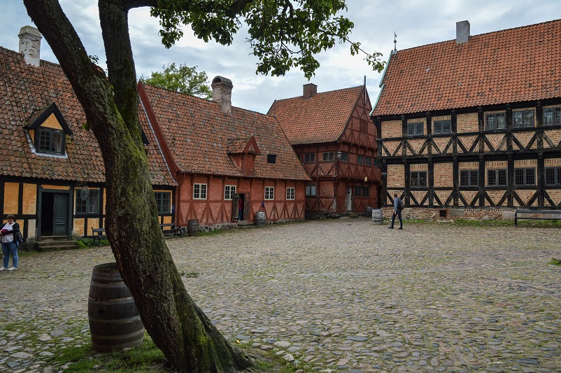 Buildings and an old tree at Den Gamle By, one of the best Aarhus museums