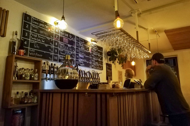 Justin looking at the tap list at Mikkeller in Aarhus