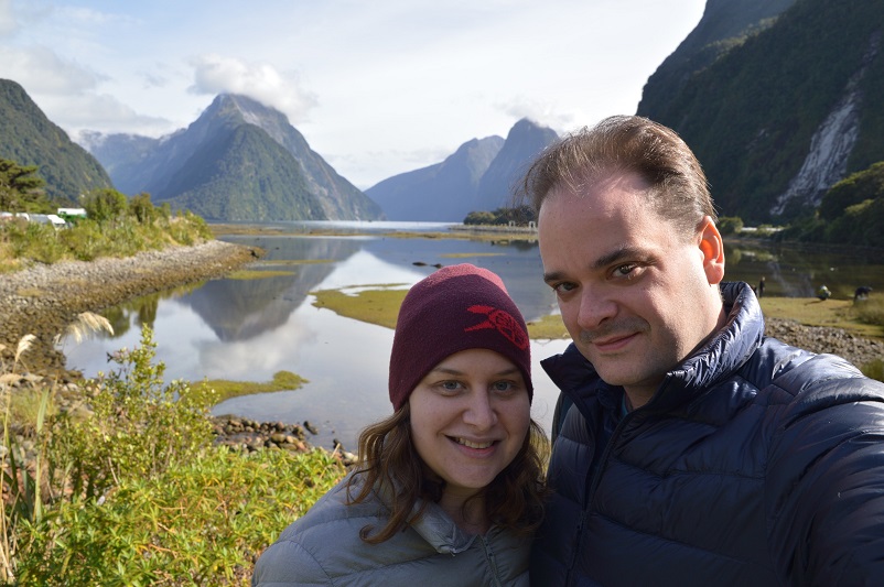 Sarah and Justin standing in front of Milford Sound in New Zealand