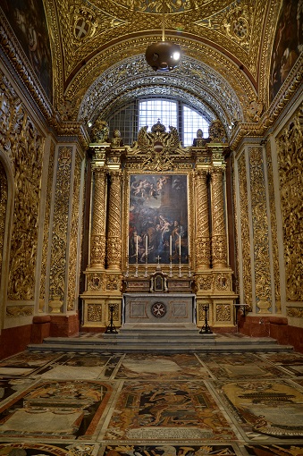 An altar and marble tombstones inside St. John’s Co-Cathedral in Valletta