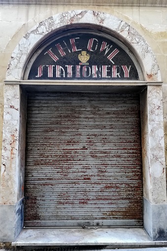 Photogenic storefront in Valletta, Malta with a sign that reads "The Owl Stationary"