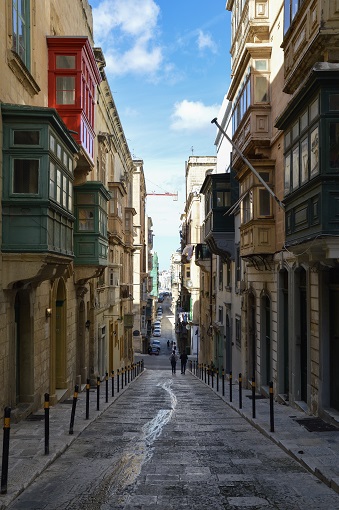Street with green balconies in Valletta, Malta