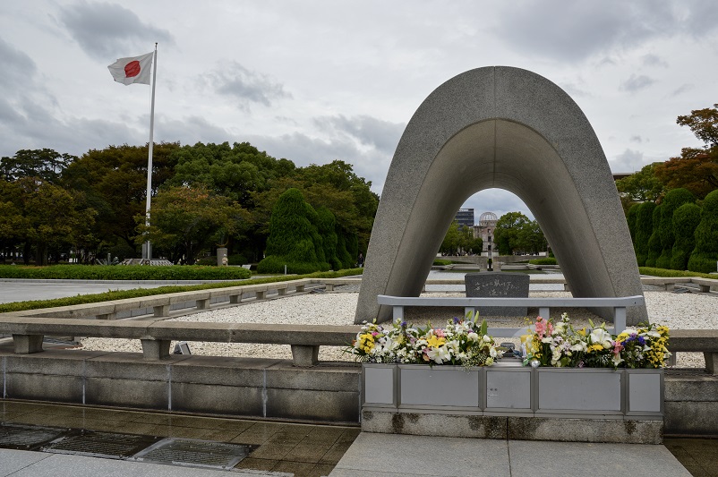 Memorial Cenotaph and Japanese flag in Hiroshima Peace Memorial Park