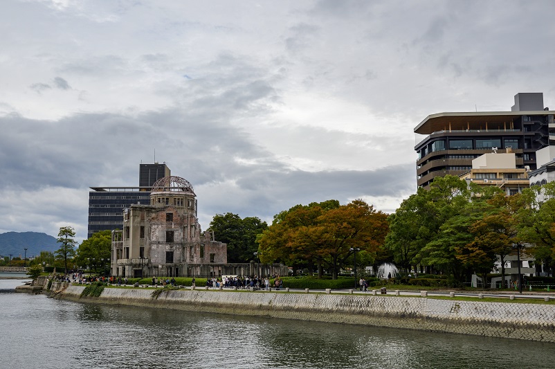 Atomic Bomb Dome standing next to trees on a river in Hiroshima