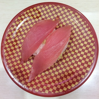 Two pieces of tuna sushi on a plate at Uobei in Tokyo